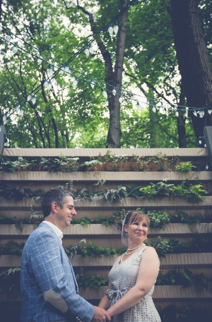 Heather + Nathan, Family Vow Renewal with Kissing on the Lips 19 Heather and Nathan hold hands Alisa Tongg Celebrant Family Vow Renewal at The Living Wall at Promise Ridge Jeremie Barlow Photography